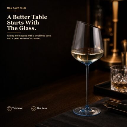 blue tinted long stem wine glass with clear bowl and angled rim on a dark dinner table