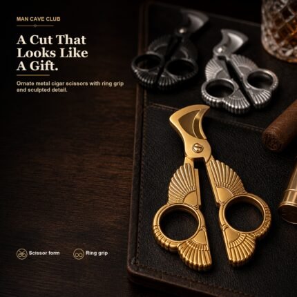 ornate stainless steel cigar scissors cutter with finger rings and embossed texture on a cigar table