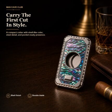 shell-textured metal guillotine cigar cutter with press opening and double blade on a cigar desk